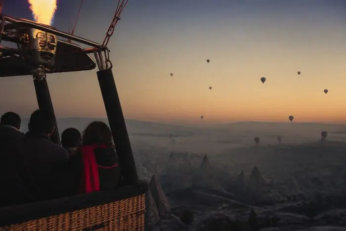 Sunrise balloon flight over the valleys